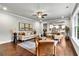 Open-concept living room with modern decor, hardwood floors, and a seamless flow to the kitchen at 7580 Sunridge Ln, Douglasville, GA 30135