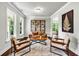 Bright living room with stylish seating, natural light, and an open floor plan with views into the dining area at 7580 Sunridge Ln, Douglasville, GA 30135