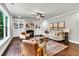 Bright living room boasts built-in shelving, a fireplace, modern furniture, and beautiful hardwood floors at 7580 Sunridge Ln, Douglasville, GA 30135