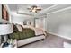 Serene main bedroom with soft lighting, tray ceiling, and neutral decor offers a relaxing atmosphere at 7580 Sunridge Ln, Douglasville, GA 30135