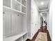 Well-organized mud room with built-in bench, storage, and hooks offers convenient access to the home at 7580 Sunridge Ln, Douglasville, GA 30135