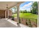 Inviting covered porch with white columns, a brick wall, and a view of the lush, green front yard at 7580 Sunridge Ln, Douglasville, GA 30135