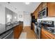 Modern kitchen with sleek granite countertops, stainless steel appliances, and warm wood cabinetry at 563 Memorial Se Dr # 504, Atlanta, GA 30312