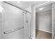 Shower with white tiles and a glass door adjacent to a walk-in closet at 563 Memorial Se Dr # 504, Atlanta, GA 30312
