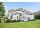 The back of the home features a large, manicured lawn and a charming patio area at 5950 Thoroughbred Way, Suwanee, GA 30024