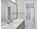 Bathroom with a modern vanity, Quartz countertop, updated fixtures and tub shower with marble tile at 5950 Thoroughbred Way, Suwanee, GA 30024