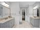 Spacious bathroom with double vanity, granite counters, tile floor, and walk-in closet at 5950 Thoroughbred Way, Suwanee, GA 30024