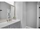 Bathroom featuring a vanity with quartz countertop and large mirror at 5950 Thoroughbred Way, Suwanee, GA 30024