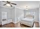 Cozy bedroom with hardwood floors, white walls, and a comfortable bed at 5950 Thoroughbred Way, Suwanee, GA 30024