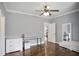 Bedroom with hardwood floors, a desk, dresser, and a view of the home's interior at 5950 Thoroughbred Way, Suwanee, GA 30024