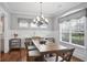 Bright dining room features hardwood floors, wainscoting, chandelier, and large windows at 5950 Thoroughbred Way, Suwanee, GA 30024