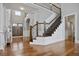 Stunning foyer features wood floors, elegant staircase, and detailed trim work at 5950 Thoroughbred Way, Suwanee, GA 30024