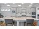 Open kitchen featuring a large island, gray cabinetry, and stainless steel appliances at 5950 Thoroughbred Way, Suwanee, GA 30024