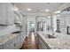 Bright kitchen with stainless steel appliances, granite countertops, and hardwood flooring at 5950 Thoroughbred Way, Suwanee, GA 30024