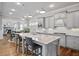 Bright, eat-in kitchen features a large center island, stainless appliances, and gray cabinetry at 5950 Thoroughbred Way, Suwanee, GA 30024