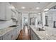 Spacious kitchen with granite countertops, stainless appliances, and view into the dining area and living room at 5950 Thoroughbred Way, Suwanee, GA 30024