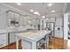 Modern kitchen with granite counters, stainless appliances, pendant lighting, large island, and breakfast bar at 5950 Thoroughbred Way, Suwanee, GA 30024