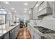 Beautiful kitchen featuring granite countertops, stainless appliances, subway tile backsplash and hardwood floors at 5950 Thoroughbred Way, Suwanee, GA 30024