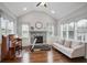 Bright and open living room with fireplace, hardwood floors, high ceilings, and plenty of natural light at 5950 Thoroughbred Way, Suwanee, GA 30024