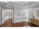 Primary bedroom showing molding and hardwood floors with entry to Primary bath at 5950 Thoroughbred Way, Suwanee, GA 30024