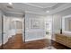 The main bedroom hallway offers a glimpse into the Primary bathroom and spacious walk-in closet at 5950 Thoroughbred Way, Suwanee, GA 30024