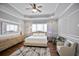 Bedroom features tray ceilings, wood floors, and a sitting area at 5950 Thoroughbred Way, Suwanee, GA 30024