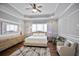 The main bedroom features tray ceilings, modern decor, and plenty of natural light at 5950 Thoroughbred Way, Suwanee, GA 30024