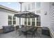 A backyard patio featuring a black dining set with an umbrella and a painted deck at 5950 Thoroughbred Way, Suwanee, GA 30024