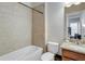 Bright bathroom featuring a tiled shower-tub, granite vanity and neutral walls at 900 River Vista Dr, Atlanta, GA 30339