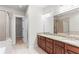Bathroom featuring double sink vanity, granite counters, and glass shower enclosure at 900 River Vista Dr, Atlanta, GA 30339