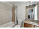 Bright bathroom featuring a tiled shower-tub, granite vanity and neutral walls at 900 River Vista Dr, Atlanta, GA 30339