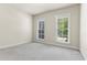 Bright bedroom featuring neutral carpeting and well-lit windows with tree views at 900 River Vista Dr, Atlanta, GA 30339