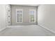 Bedroom featuring neutral carpet, base trim, and double window at 900 River Vista Dr, Atlanta, GA 30339