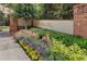 Community entrance sign with lush landscaping and a decorative brick wall at 900 River Vista Dr, Atlanta, GA 30339