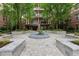 Beautifully landscaped courtyard with stone benches, a central water feature and the building's facade at 900 River Vista Dr, Atlanta, GA 30339