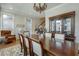 Inviting dining room featuring a large wooden table, chandelier, and bright windows at 900 River Vista Dr, Atlanta, GA 30339