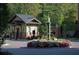 Inviting community entrance featuring a water fountain surrounded by beautiful flower beds at 900 River Vista Dr, Atlanta, GA 30339