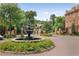 Elegant entrance with fountain, flowers, brick pathway, and manicured landscaping at 900 River Vista Dr, Atlanta, GA 30339