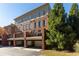 Townhome exterior showcasing balconies and garages, surrounded by lush landscaping at 900 River Vista Dr, Atlanta, GA 30339
