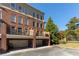 Beautiful townhome exterior featuring private balconies and well-manicured lawns at 900 River Vista Dr, Atlanta, GA 30339
