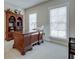 Bright home office with classic wooden desk, bookcase, and natural light from windows at 900 River Vista Dr, Atlanta, GA 30339