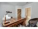 Well-lit home office space with a view to the stairs and bathroom at 900 River Vista Dr, Atlanta, GA 30339