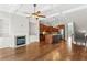 Open-concept living room with hardwood flooring, a fireplace, and an open kitchen at 900 River Vista Dr, Atlanta, GA 30339