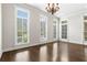 Bright living room with large windows, hardwood floors, and elegant chandelier at 900 River Vista Dr, Atlanta, GA 30339