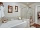 Bathroom featuring a soaking tub, a glass enclosed shower and a walk-in closet at 900 River Vista Dr, Atlanta, GA 30339