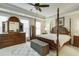 Spacious main bedroom with a four-poster bed, ceiling fan, and neutral decor at 900 River Vista Dr, Atlanta, GA 30339