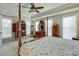 Brightly lit main bedroom featuring a four-poster bed and lots of storage at 900 River Vista Dr, Atlanta, GA 30339
