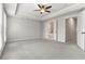 Spacious main bedroom with tray ceiling, ceiling fan, and ensuite bathroom access at 900 River Vista Dr, Atlanta, GA 30339