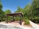 Relaxing outdoor pergola with bench seating nestled amongst lush greenery and a paved walkway at 900 River Vista Dr, Atlanta, GA 30339