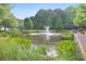 Scenic pond featuring a water fountain and lush landscaping surrounding the area at 900 River Vista Dr, Atlanta, GA 30339